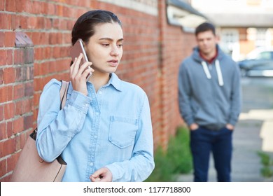 Woman Calling For Help On Mobile Phone Whilst Being Stalked On City Street By Man