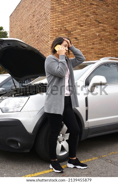 woman\
calling on her cell phone about her stranded\
car