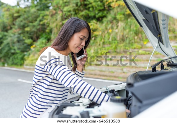 Woman calling\
others with repairing the\
car