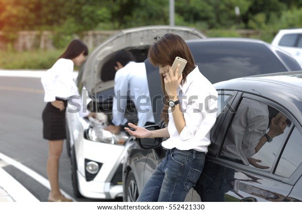 Woman calls for help and\
insurrance require by mobile phone after accident of car\
occurrence