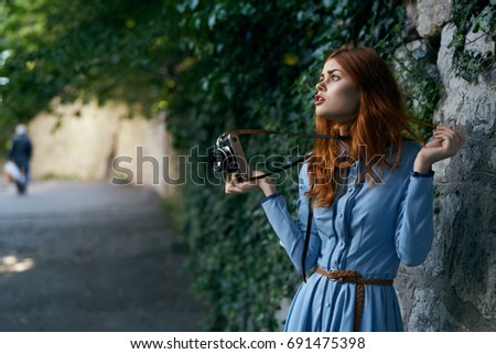Woman with camera in blue dress                               