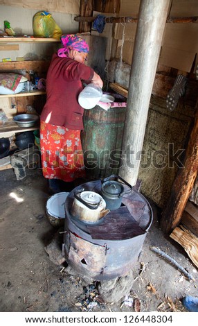 The woman at the camp prepares koumiss in the traditional way