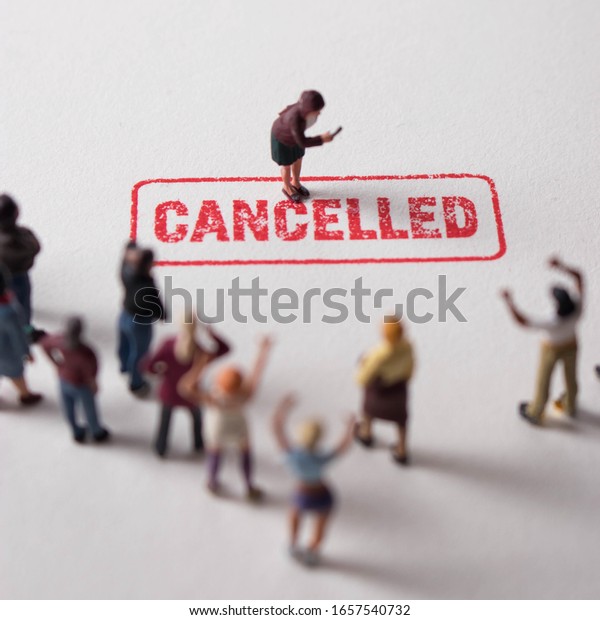 Woman with cancelled stamp in front of angry\
mob. Person is the latest victim of toxic cancel culture. Girl is\
bullied or excluded by friends, family, social media followers.\
Offensive woman labelled.