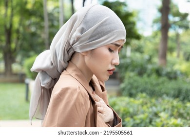 Woman Cancer Patient Having Pain With Treatment Adverse Effect, Wearing Head Scarf Due To Post Chemotherapy Hair Loss And Painful Radiation Therapy Side Effect