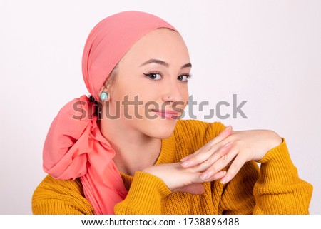 woman with cancer poses with a pink scarf happy