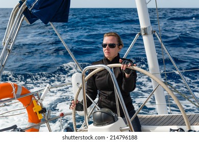 Woman Captain At The Helm Of Big Cruising Yacht