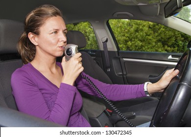 Woman In Car Blowing Into Breathalyzer