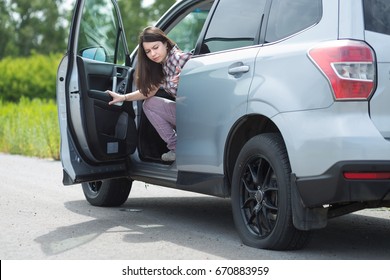 Woman With Car Broken Down, Flat Tire, Close Up