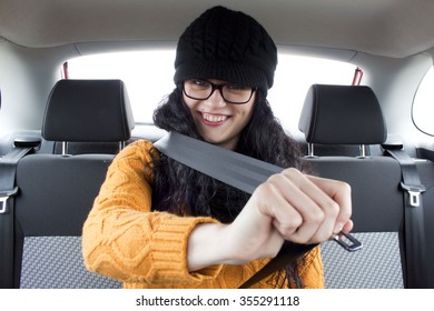 Woman In A Car Fasting Her Seat Belt