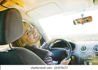 Woman In Car Indoor Keeps Wheel Turning Around Smiling Looking At Passengers In Back Seat Idea Taxi Driver Talking To Police Companion Companion Who Asks For Directions Right To Drive Documents Exam