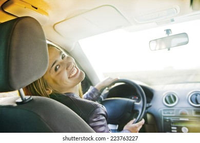 Woman In Car Indoor Keeps Wheel Turning Around Smiling Looking At Passengers In Back Seat Idea Taxi Driver Talking To Police Companion Companion Who Asks For Directions Right To Drive Documents Exam