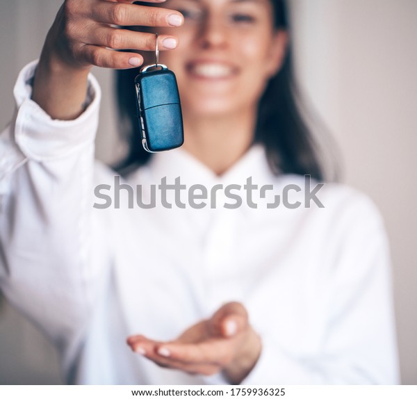Woman with a car keys. Isolated on white background.\
Smile woman. Key. \
