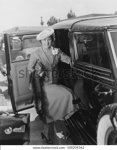 Woman with car and\
luggage