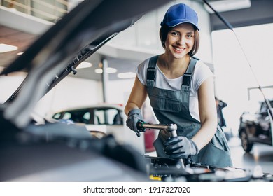 Woman Car Mechanic Checking Vehicle And Engine