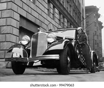 Woman with car on city street