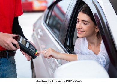 Woman In Car Paying Card Reader Payment Terminal After Refuel Car Spending Instead Of Cash With Man Service Employee At Gas Station. Petrol Business Finance Energy Concept.