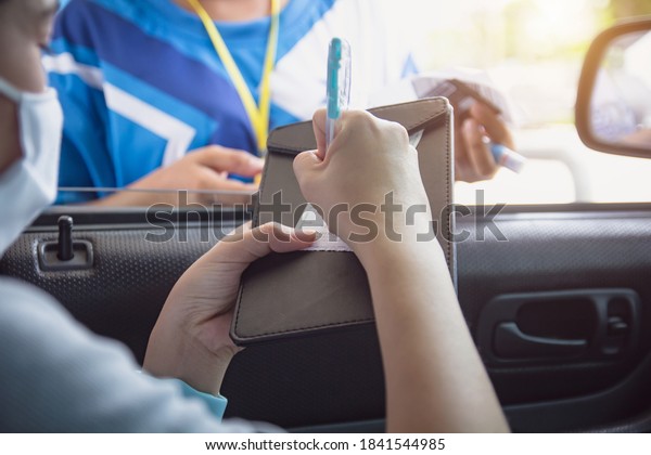 Woman in car paying gasoline with credit card,\
female holding debit card payment at gas station. Petrol oil\
loyalty mileage point reward for cash money. Driver sign for paying\
fuel with credit card.