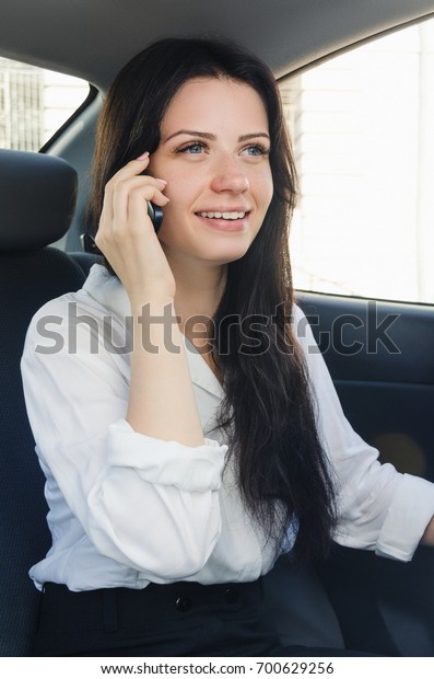 Woman in car with phone. Businesswoman in car.\
Modern woman.
