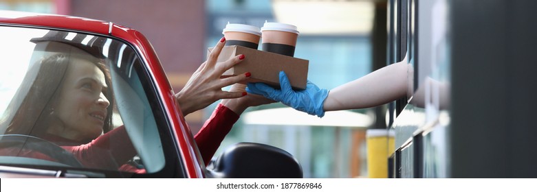 Woman In A Car Picks Up Drinks From Dispensing Point. Fast Food And Takeaway Concept