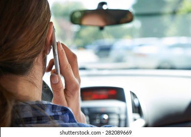 Woman In Car Talking On Mobile Phone Whilst Driving