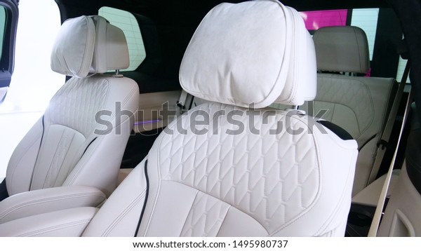 A woman at a car wash does a full dry-cleaning of\
all parts of a car using special chemistry, cloths, sponges and\
brushes. Concept of: Full car cleaning, Dry cleaning, Professional\
service. Car, Work.