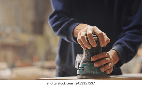 Woman carpenter sanding wood block. Girl process timber bar close up. Male carpentry work skill. Female joiner woodwork. Guy worker. Person man use sander tool. Diy master class workshop. Job project. - Powered by Shutterstock