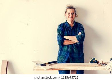 Woman Carpenter Working On A Wood