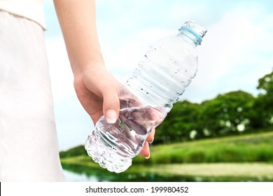 A Woman Carrying The Bottle Of The Water In The Park. Water From Nature. Don't Dump Plastic. 