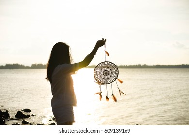 Woman Carrying A Dream Catcher On The Seashore