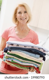 Woman Carrying Folded Up Laundry