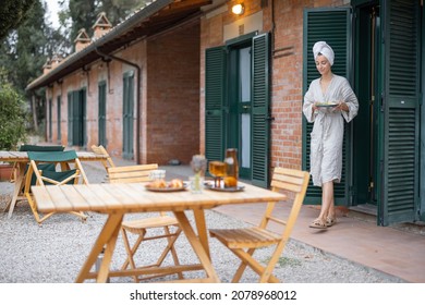 Woman Carrying Food To Table For Breakfast During Resting In Hotel At Morning Time. Concept Of Weekend, Tourism And Vacation. Young Caucasian Woman Wearing Bathrobe And Wrapped Bath Towel On Head