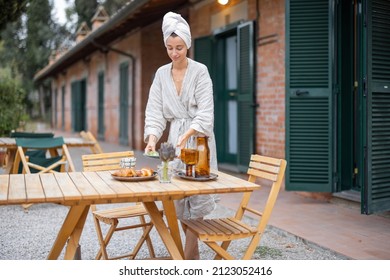 Woman Carrying Food To Table For Breakfast During Resting In Hotel At Morning Time. Concept Of Weekend, Tourism And Vacation. Young Caucasian Woman Wearing Bathrobe And Wrapped Bath Towel On Head