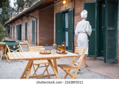 Woman Carrying Food To Table For Breakfast During Resting In Hotel At Morning Time. Concept Of Weekend, Tourism And Vacation. Young Caucasian Woman Wearing Bathrobe And Wrapped Bath Towel On Head