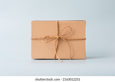 Woman Carrying Gift Paper Box Tie Cute Ribbon For Special Occasion. Delivery Sending Present To Someone Special To Thank Or Surprise.