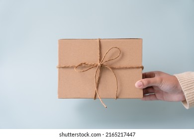 Woman Carrying Gift Paper Box Tie Cute Ribbon For Special Occasion. Delivery Sending Present To Someone Special To Thank Or Surprise.