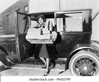 Woman carrying packages from car