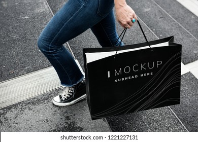 Woman carrying a shopping bag mockup