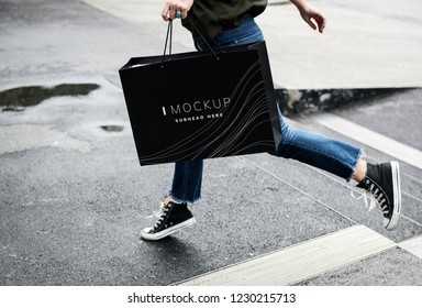 Woman carrying a shopping bag mockup