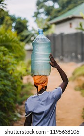 Woman Carrying Water Can In Uganda, Africa