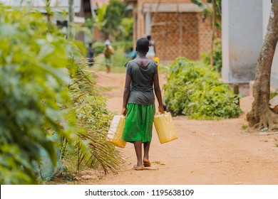 Woman Carrying Water Can In Uganda, Africa