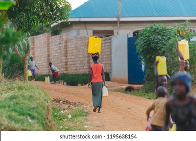 Woman Carrying Water Can In Uganda, Africa