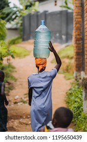 Woman Carrying Water In Uganda, Africa