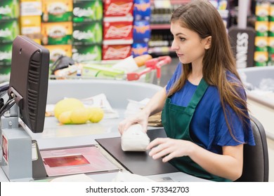 Woman Cashier Beeping An Item On A Grocery