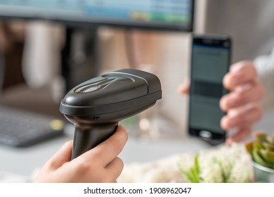 Woman Cashier Scanning Qr Code From Buyer Phone Using Barcode Scanner. Man Buying A Gift In A Female Clothing Store Using Promo Code.  