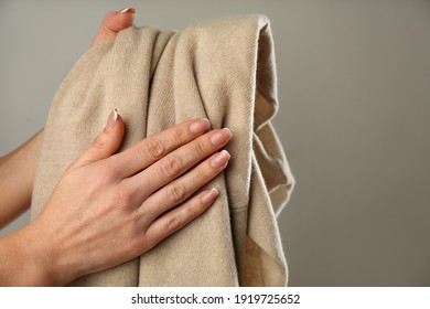 Woman With Cashmere Sweater On Beige Background, Closeup