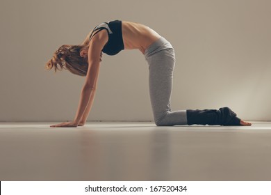 Woman In The Cat Yoga Pose.