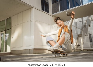 woman caucasian beautiful female have fun with skateboard happy smile take selfie photo self portrait use smarthone mobile phone - Powered by Shutterstock