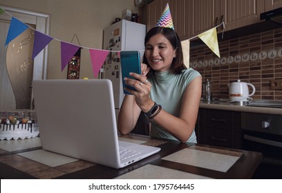 Woman celebrating birthday online in quarantine time. Woman celebrating her birthday through video call virtual party with friends. Authentic decorated home workplace. Coronavirus outbreak 2020. - Powered by Shutterstock