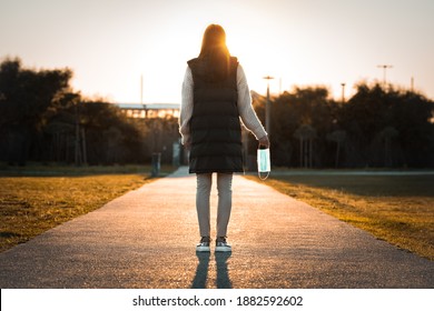 Woman celebrating without mask. Take off the mask. The end of coronavirus pandemic. Recovered from coronavirus. Defeating illness. Coronavirus quarantine is over. We won. Walking without mask. - Shutterstock ID 1882592602