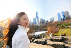 Woman In Central Park, New York City In Late Fall Early Winter With Skating Rink In Background. Candid Smiling Multi-ethnic Girl On Manhattan, USA.